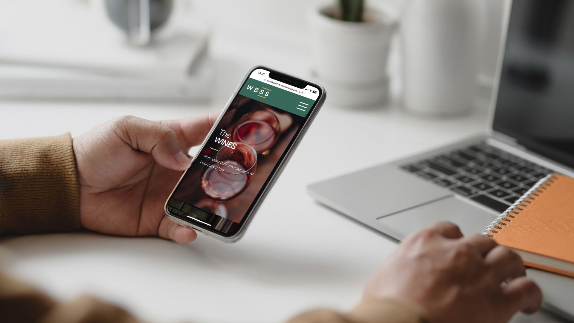 Someone holding an iphone 11 scrolling the website